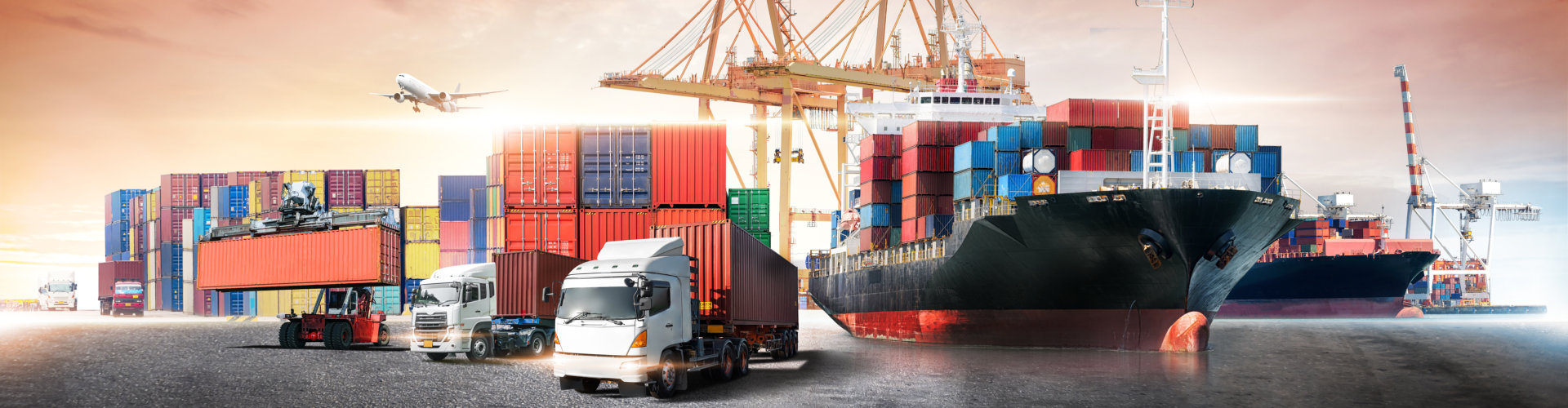 cargo trucks and cargo ship in shipping yard