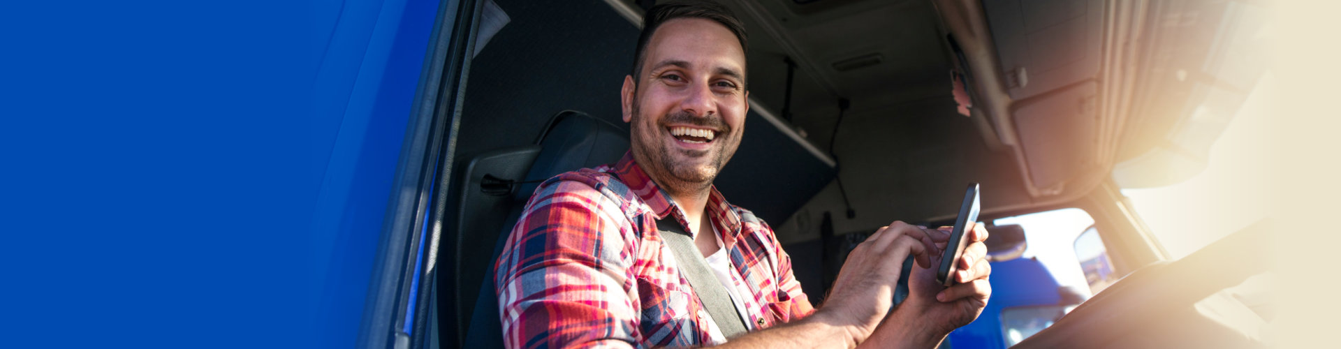 cheerful truck driving holding a tablet