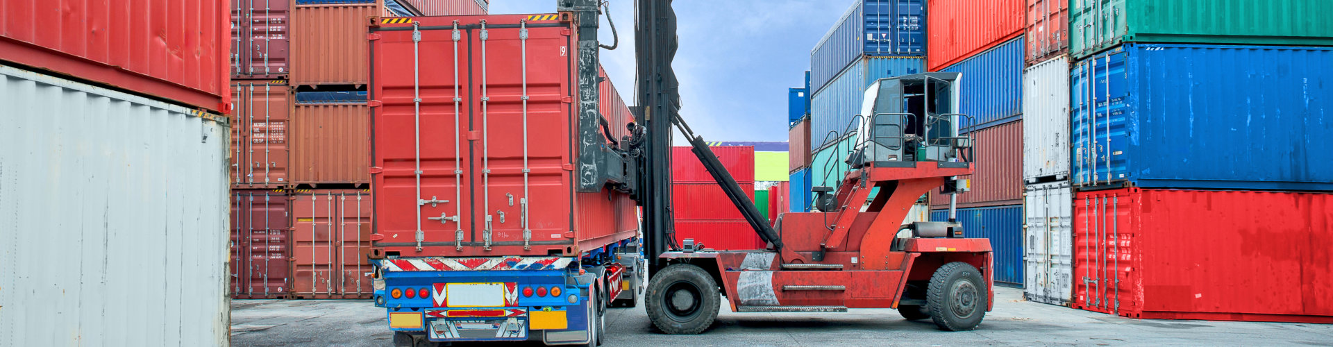 forklift handling container box loading to truck in dock